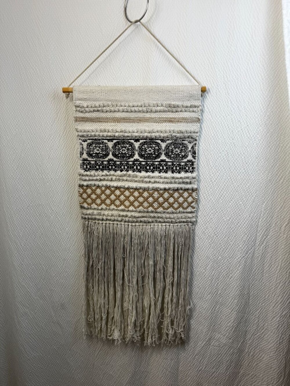 Boho-Inspired Woven Wall Hanging With Fringe And Intricate Black & Tan Patterns